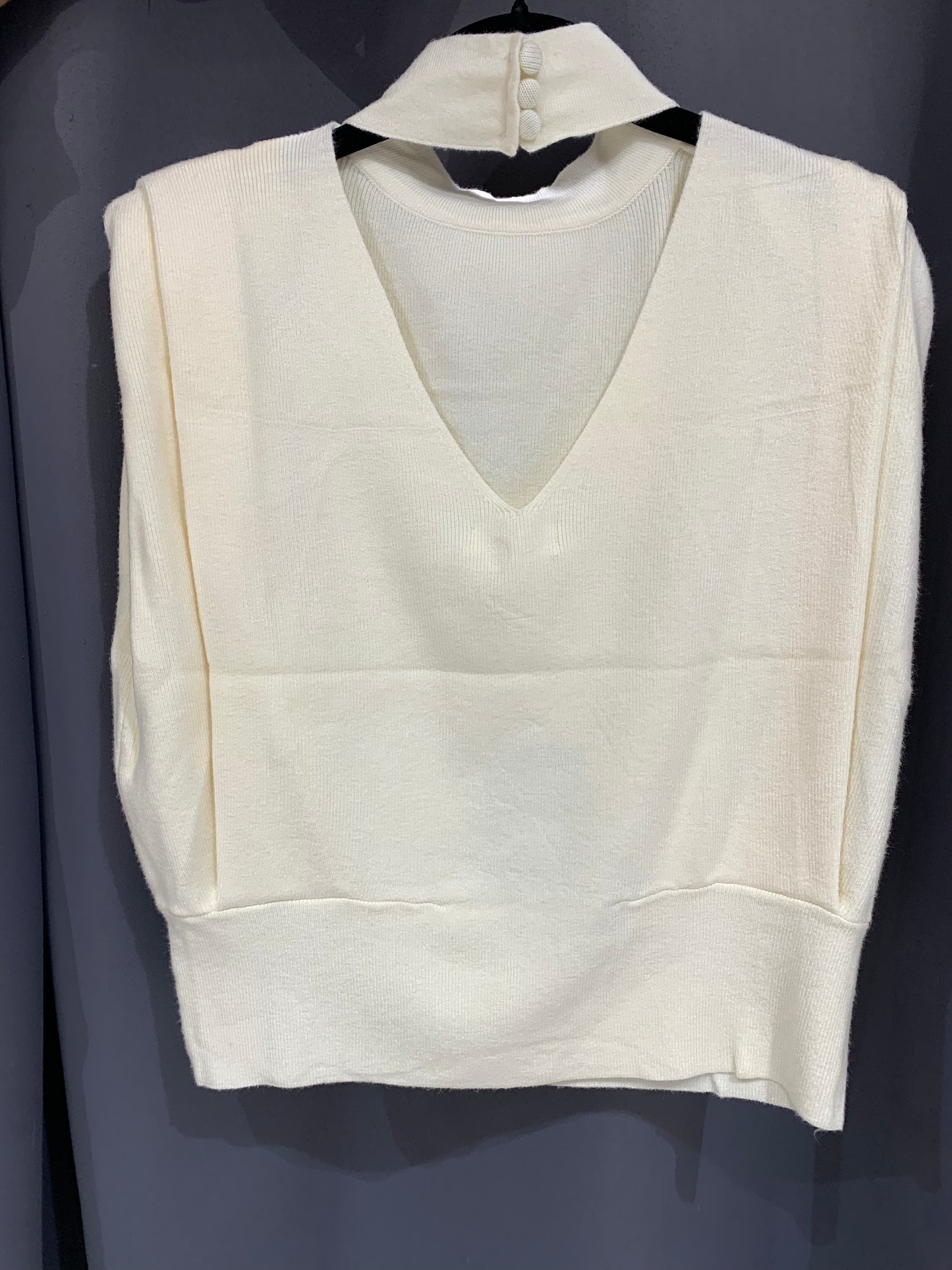 Pull sans manches col montant et dos ouvert à boutons