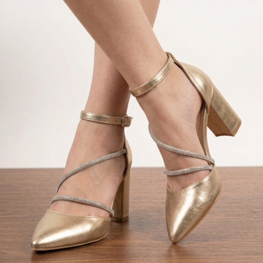 Two-tone black and gold pointed toe pumps with criss-cross rhinestone straps